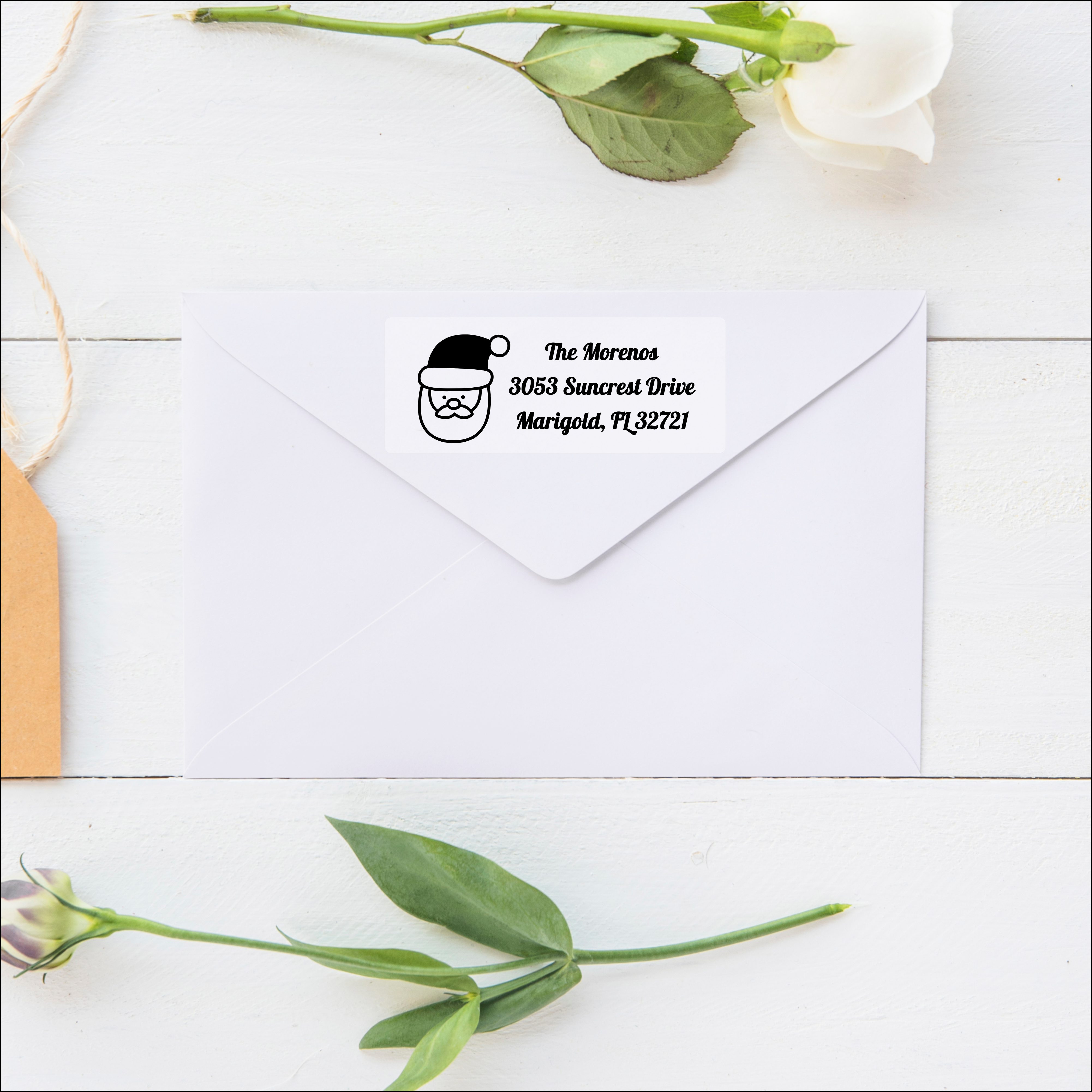 Santa Claus Christmas label on top of a white envelope Santa Claus Christmas label on top of a white envelope